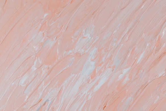 The image features a close-up of thick, textured brushstrokes in varying shades of pale peach and white, creating an abstract pattern. The brushwork appears dynamic, with a mixture of smooth and rugged textures, adding depth to the visual composition.