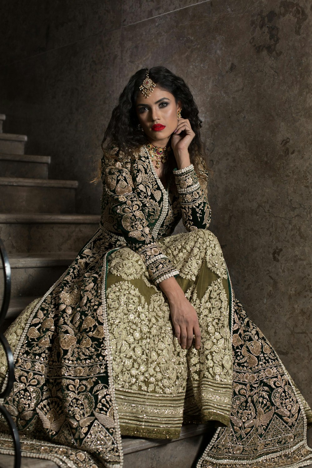 woman in brown and beige floral dress sitting on chair