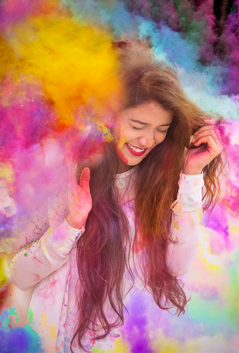 woman in white long sleeve shirt with purple yellow and blue powder on her face