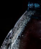 A close-up of a sparkling Amethyst Beverage bottle with condensation.