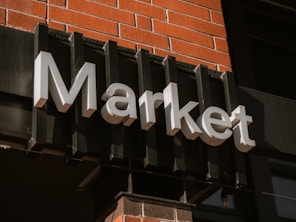 a sign on the side of a building that says market