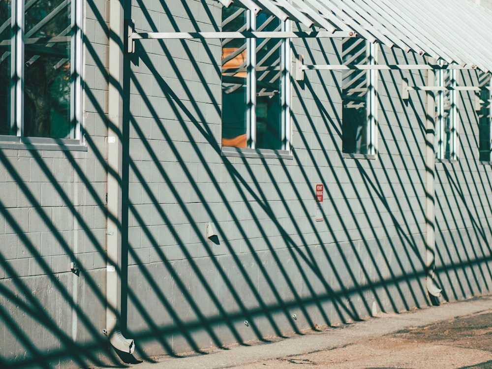 gray metal fence with green and yellow flag