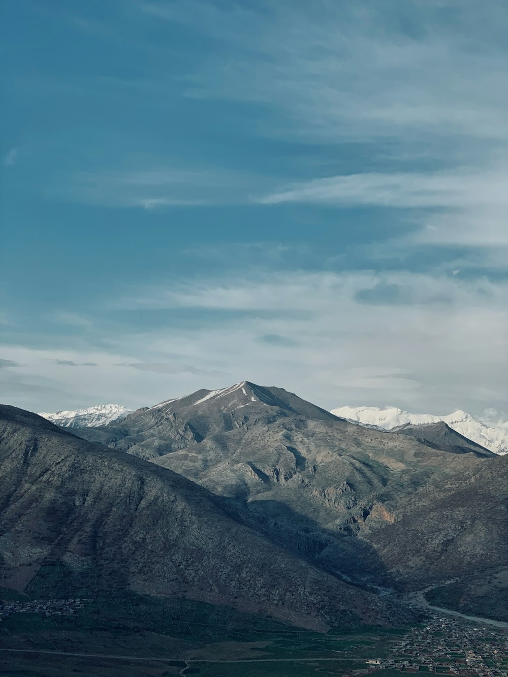 green and brown mountains under white clouds and blue sky during daytime