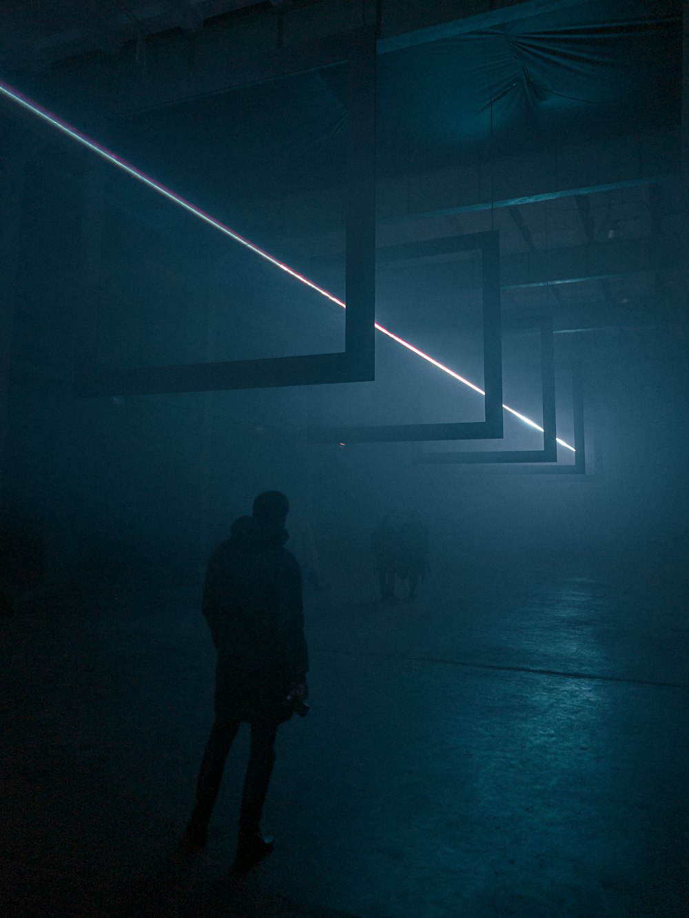 silhouette of man walking on hallway