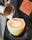 A barista pouring coffee into a cup with latte art.