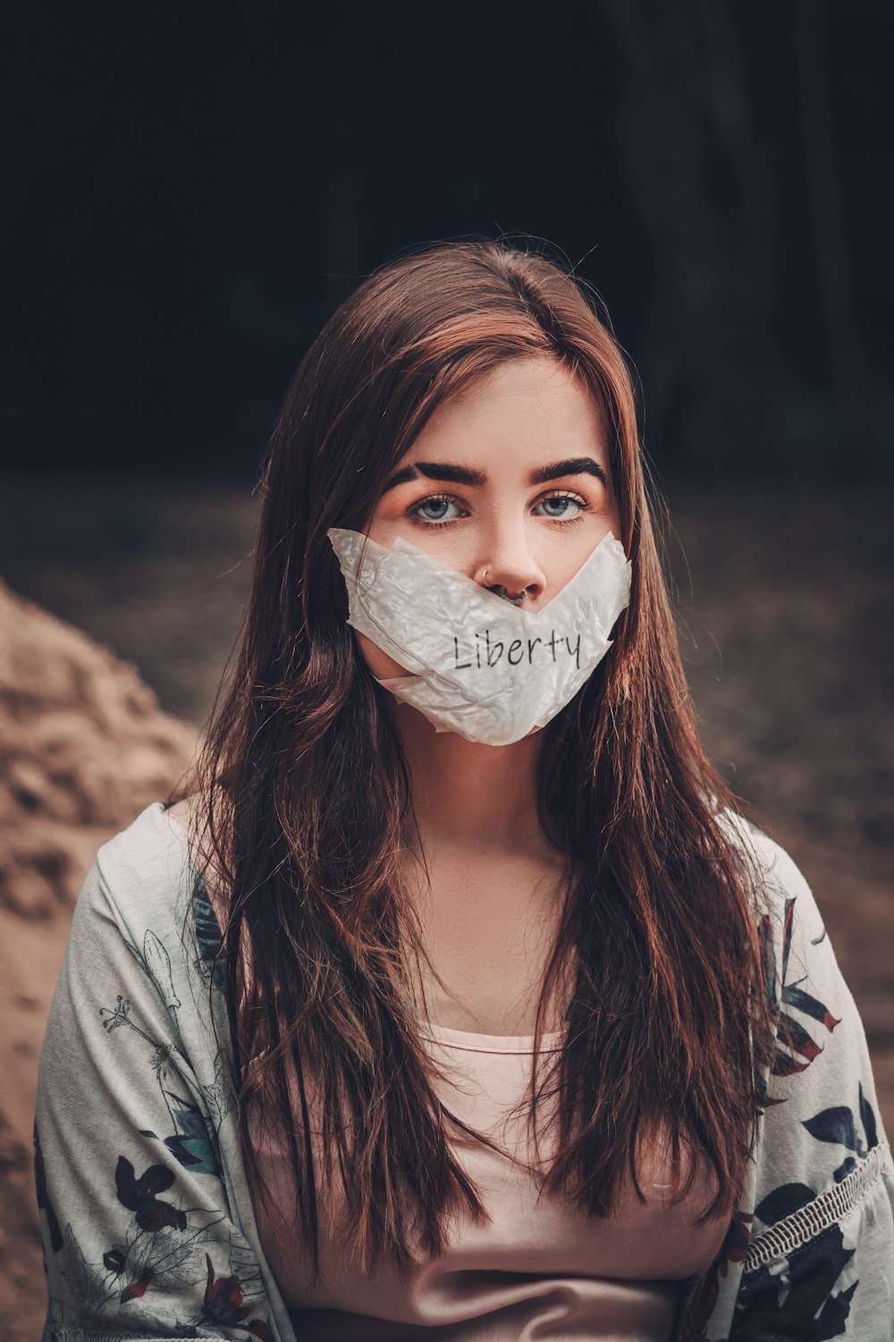 woman in gray blazer with white face mask