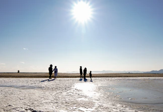 A bright beach scene in St. Augustine with sunlit waves and visitors enjoying the shore.