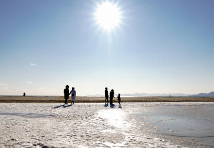 A bright beach scene in St. Augustine with sunlit waves and visitors enjoying the shore.