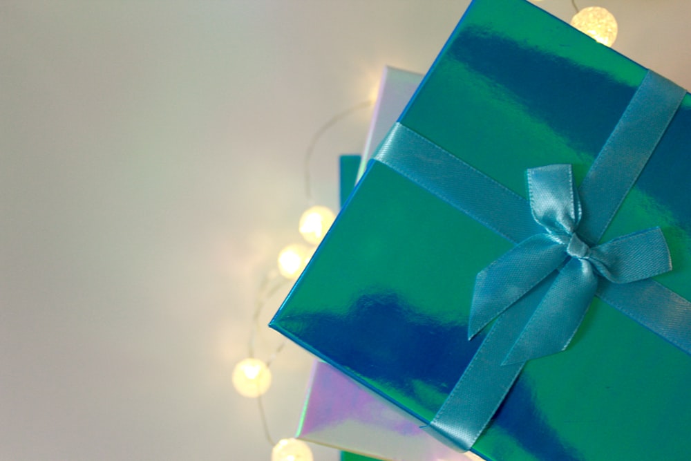 green gift box with white ribbon