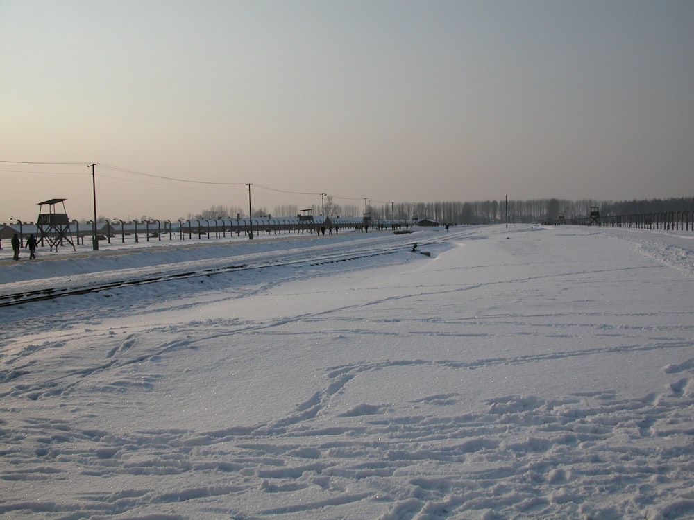 snow covered field with bridge during daytime