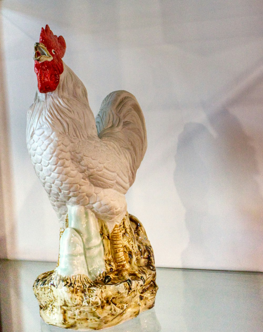 white and red rooster figurine