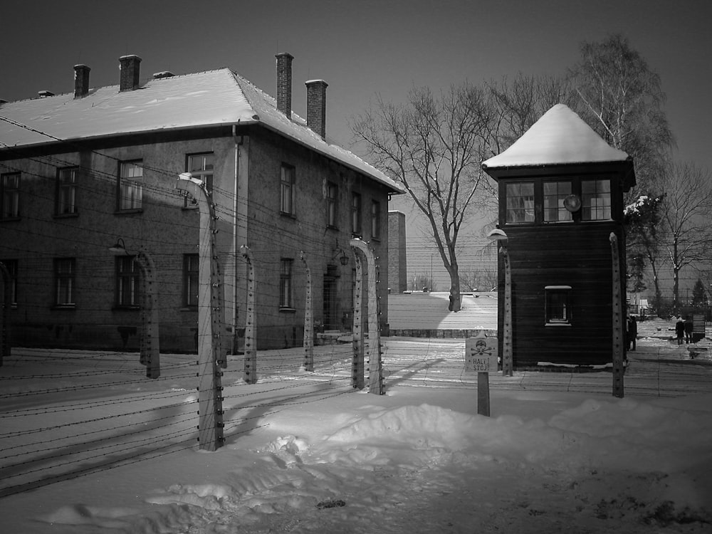 grayscale photo of house on snow covered ground