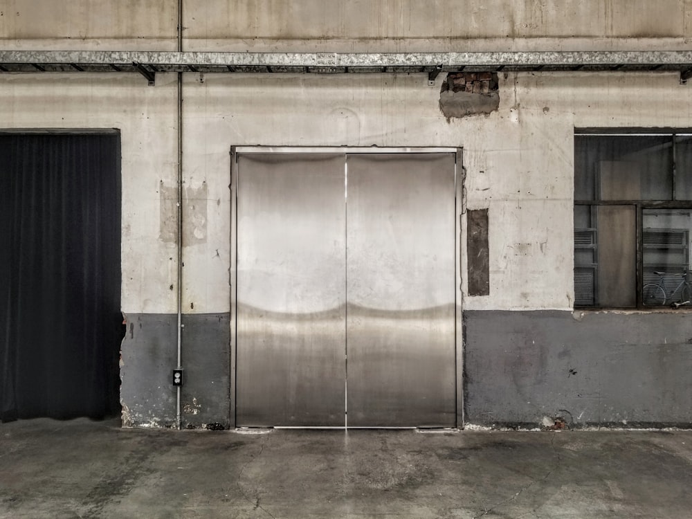 blue wooden door on white concrete building