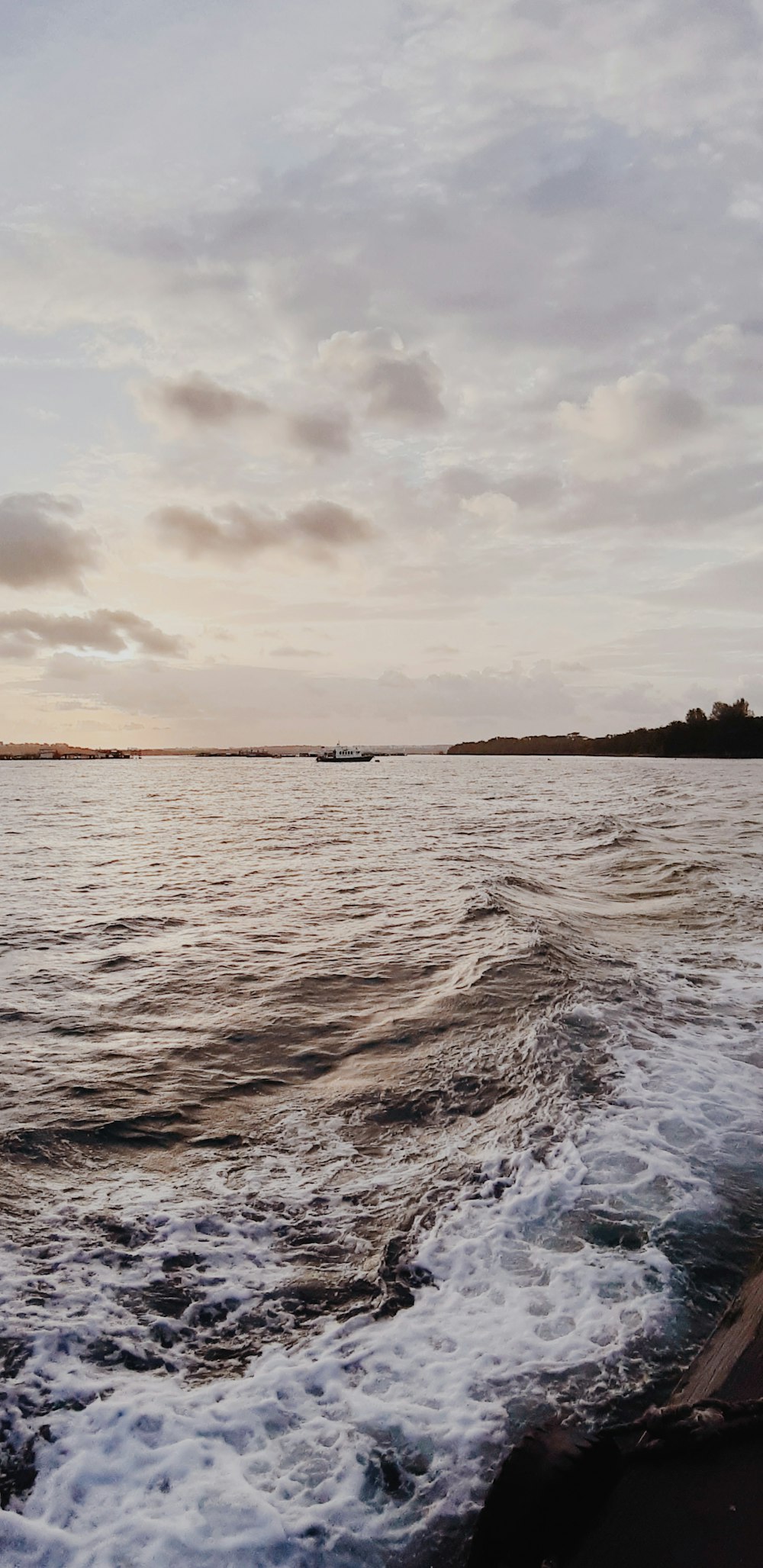 body of water under cloudy sky during daytime