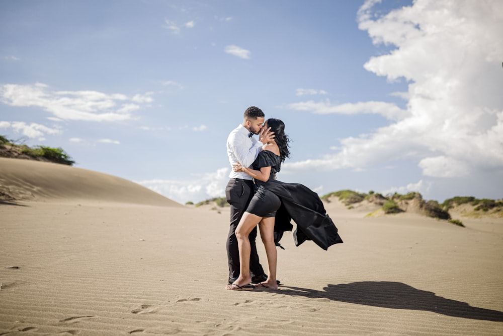 woman in white long sleeve shirt and black skirt walking on brown sand during daytime