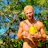 A smiling middle-aged man standing in a lush coconut plantation holding a fresh coconut.
