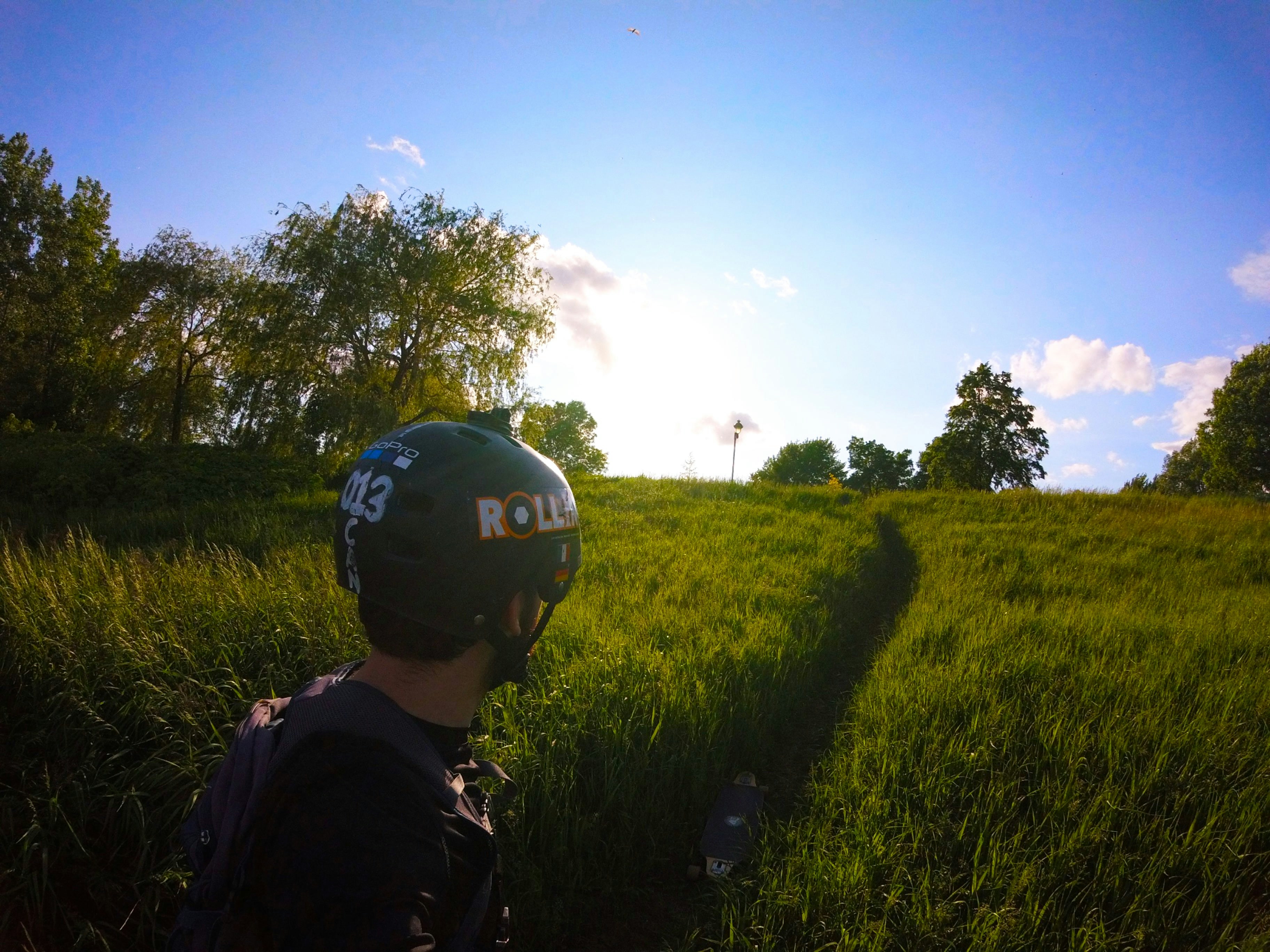 man in black jacket standing on green grass field during daytime