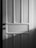 A wooden door with a classic panel design featuring clear vertical and horizontal sections. The image is in black and white, casting soft shadows across the surface.