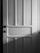 A wooden door with a classic panel design featuring clear vertical and horizontal sections. The image is in black and white, casting soft shadows across the surface.