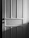 A wooden door with a classic panel design featuring clear vertical and horizontal sections. The image is in black and white, casting soft shadows across the surface.