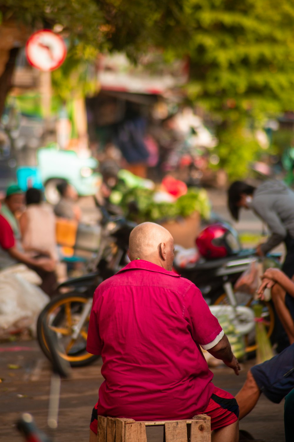 man in red shirt riding motorcycle during daytime