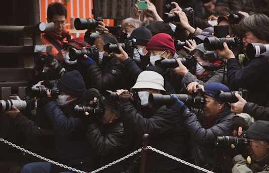 people in black jacket taking photo