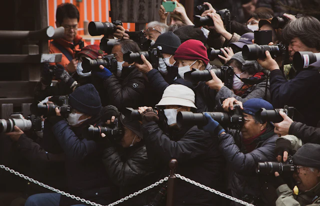 Photographers with their cameras raised
