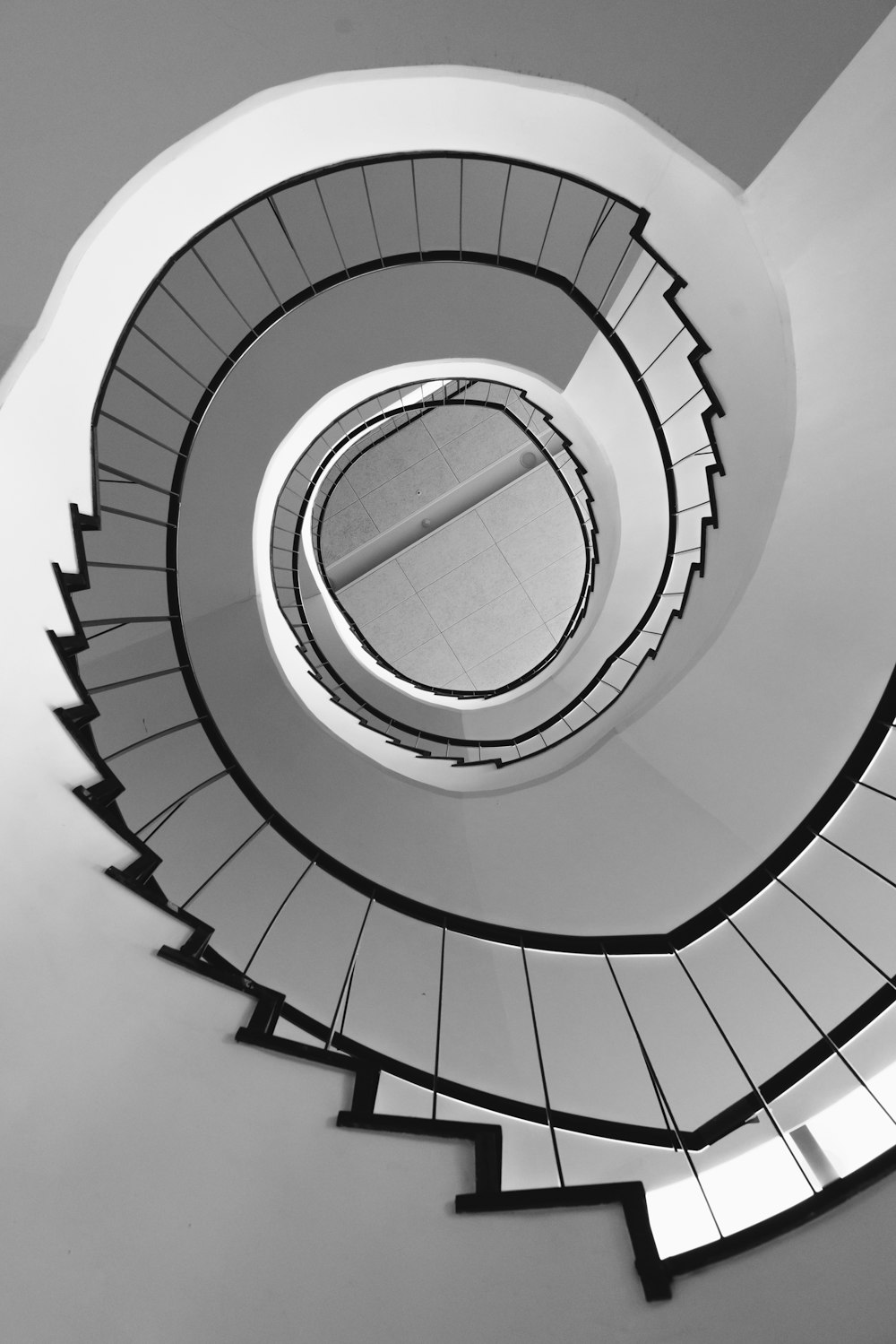 white spiral staircase with white railings