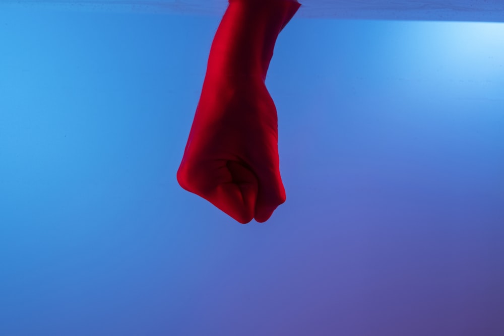 person holding red cotton sock