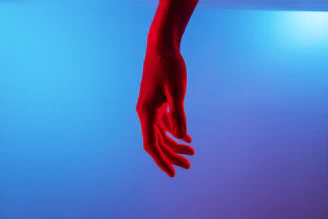 persons left hand on blue surface
