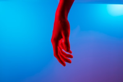 persons left hand on blue surface touching teams background