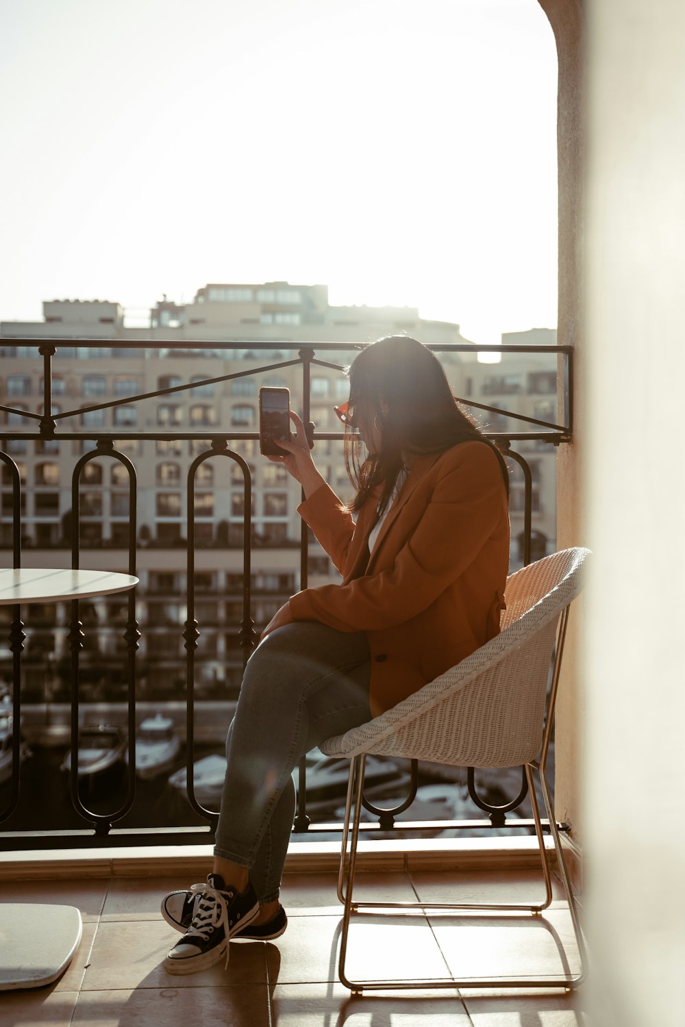 woman in orange shirt sitting on chair