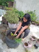 Kids planting small flowers in a sunny garden area.