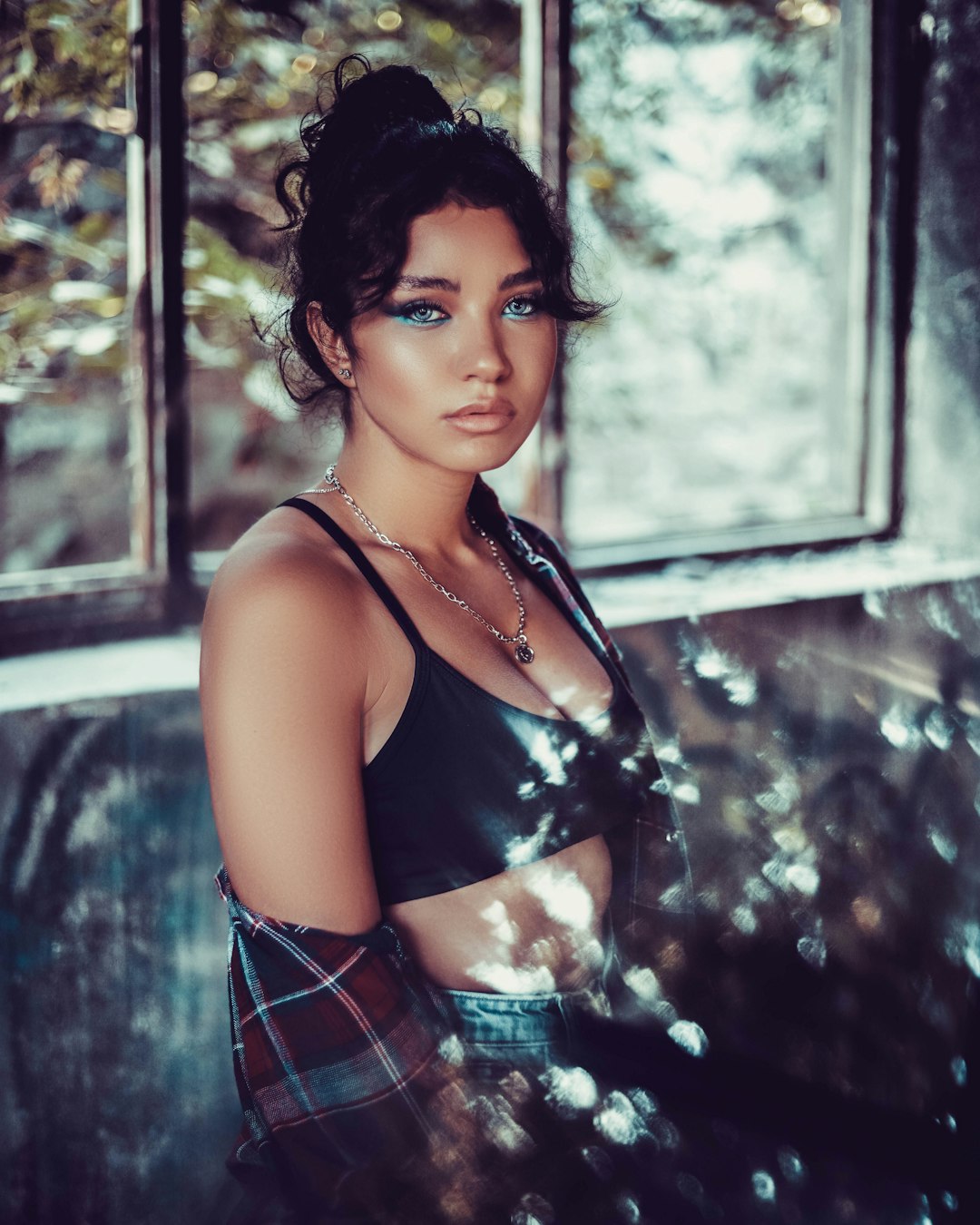 woman in black tank top and blue and white plaid skirt