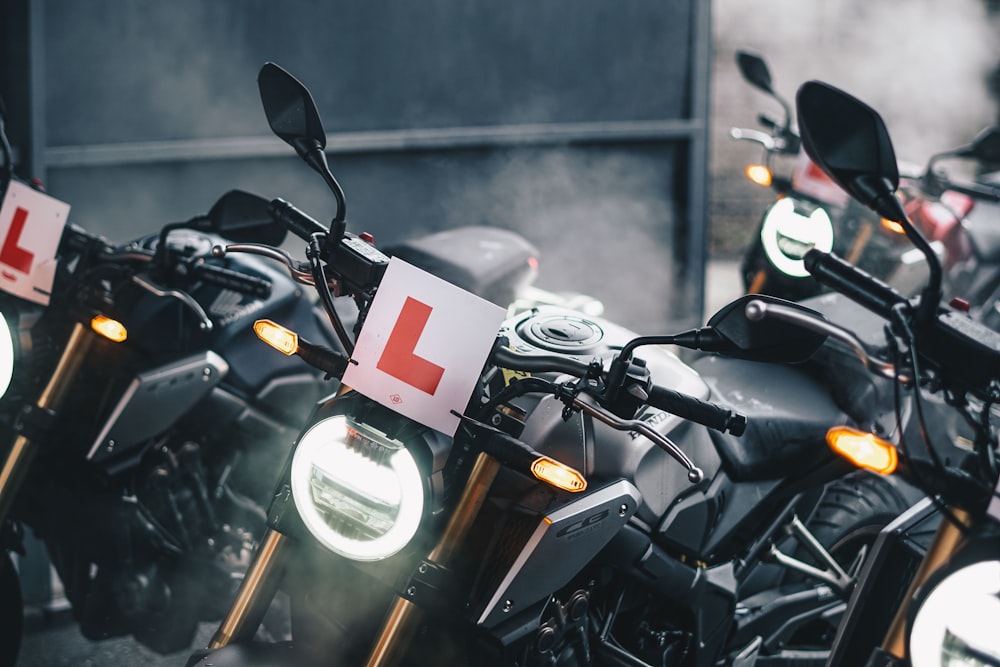 black motorcycle parked beside wall