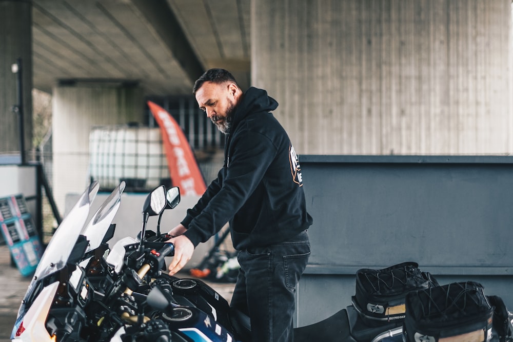 man in black jacket riding on black motorcycle