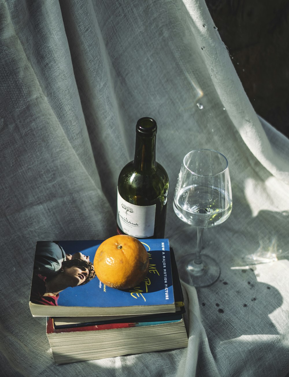 wine bottle beside wine glass on table