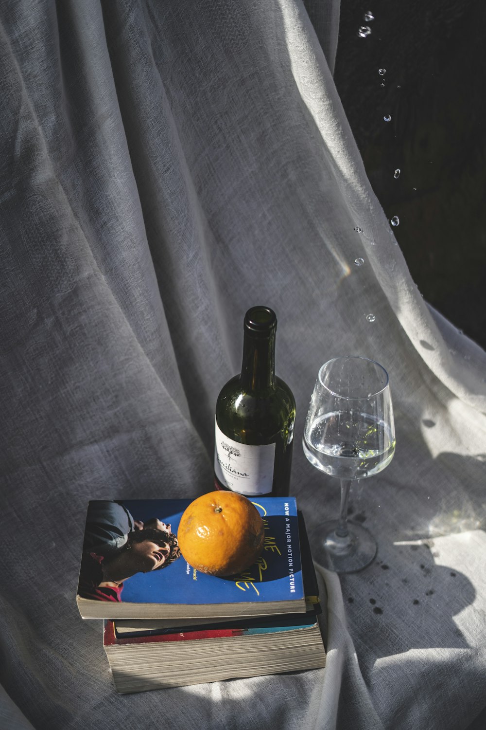 wine bottle beside wine glass on table
