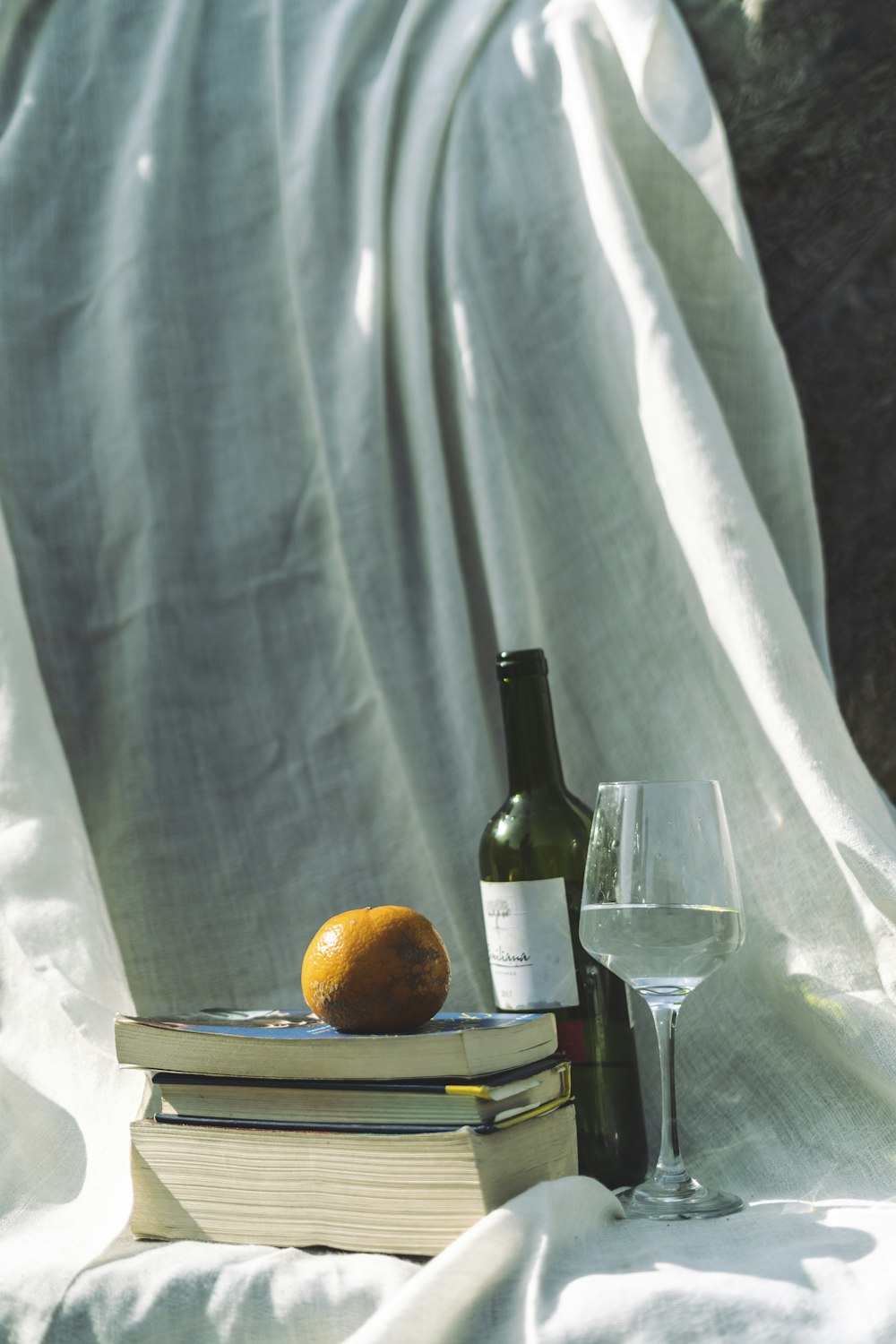 orange fruit beside wine bottle on table