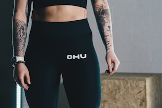 woman in black sports bra and blue leggings
