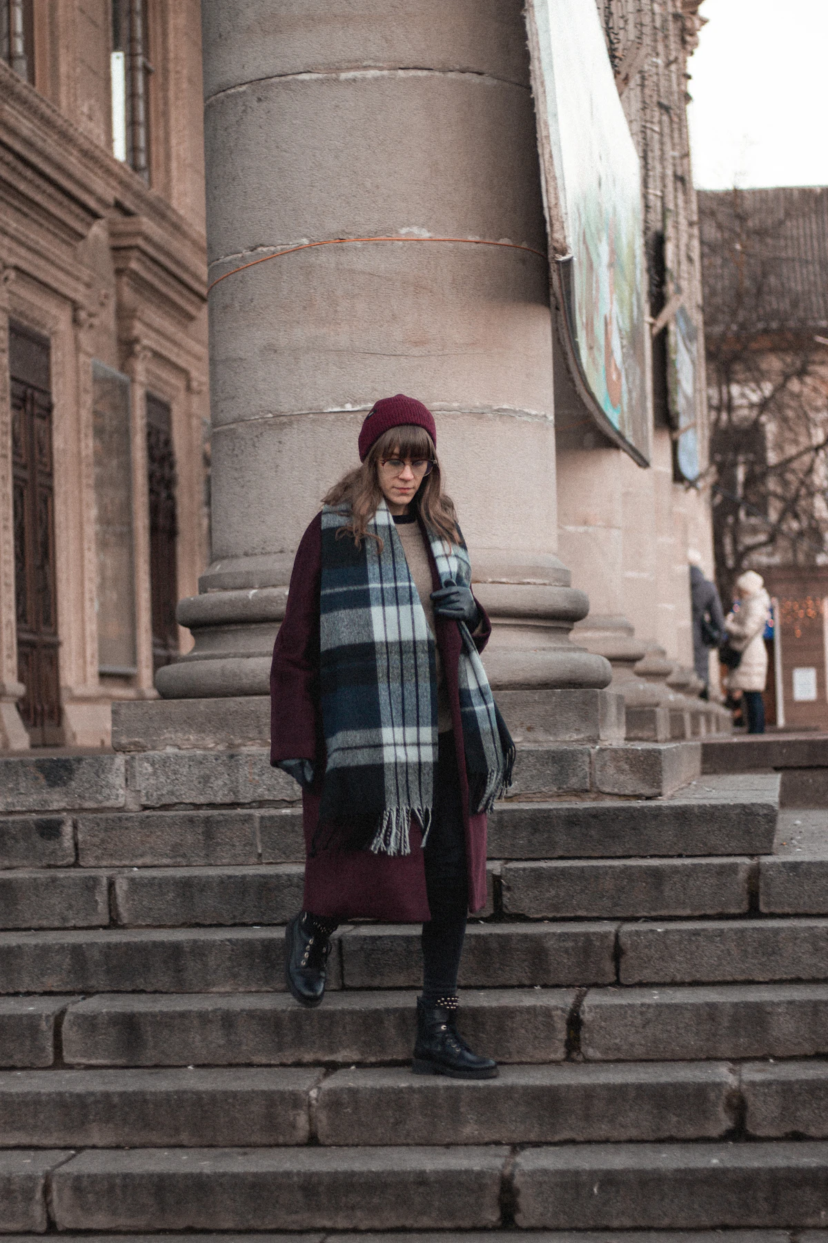 Person bundled in winter layers walking through snowy city street