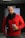 man in red sweater holding white and blue ceramic mug