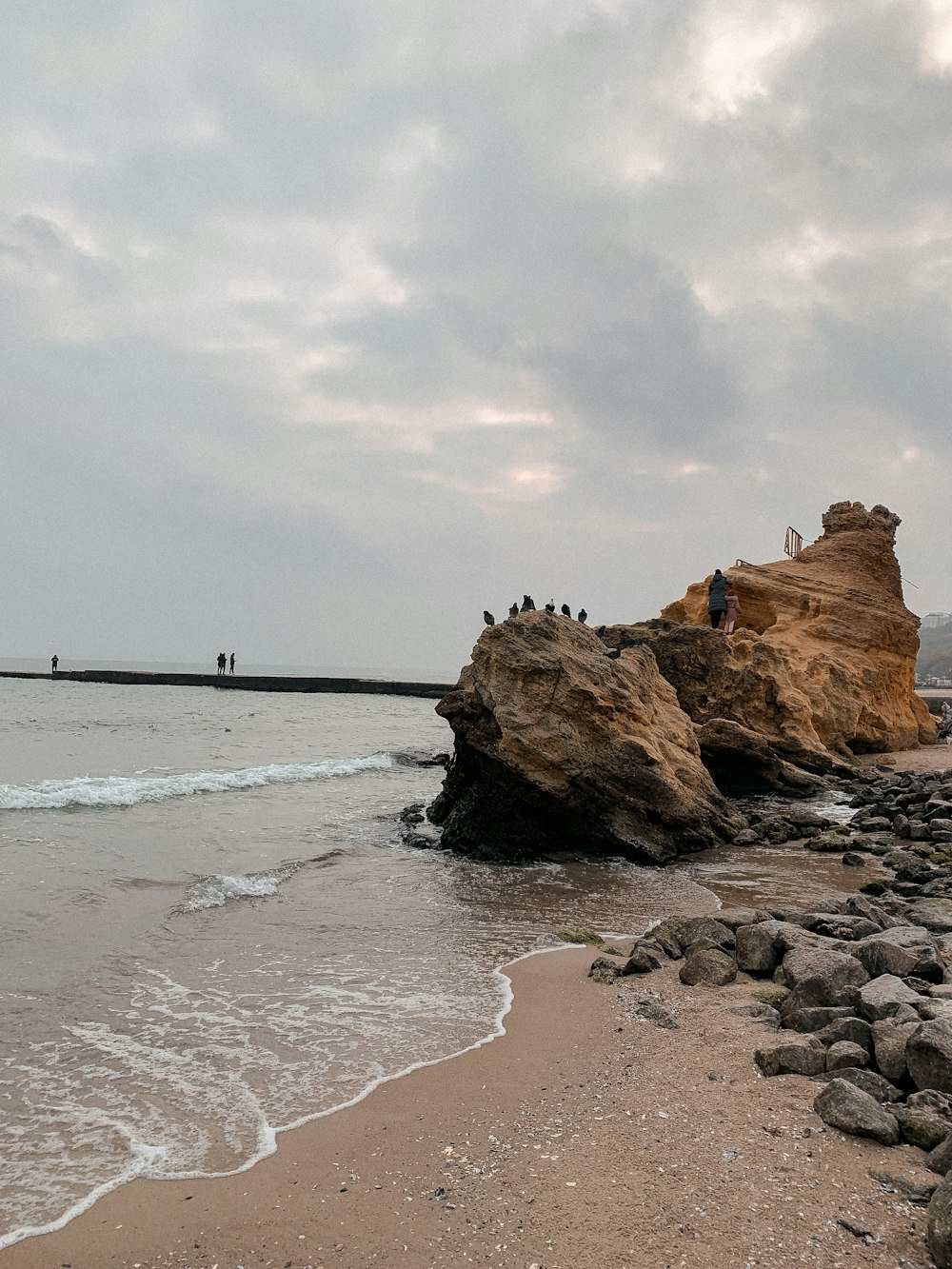 brown rock formation on sea shore during daytime