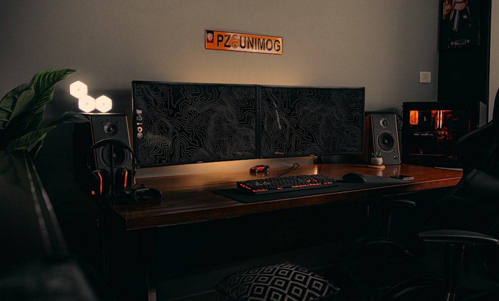 black flat screen computer monitor on brown wooden desk