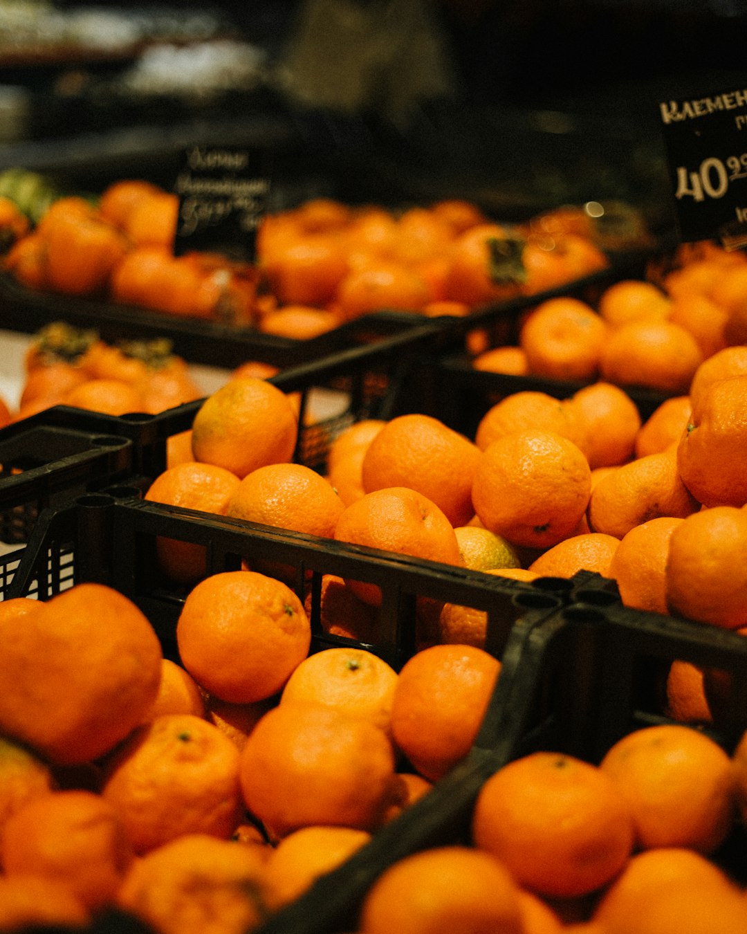 orange fruits on black plastic crate