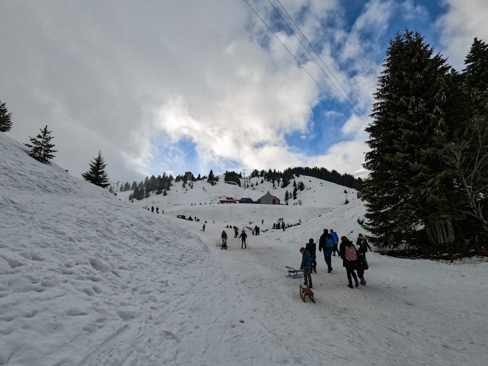 people hiking on snow covered mountain during daytime