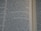 Close-up view of an open book showing text from a religious or historical scripture. The passage focuses on an instruction involving the behavior of men drinking water, emphasizing the separation based on how they drink.