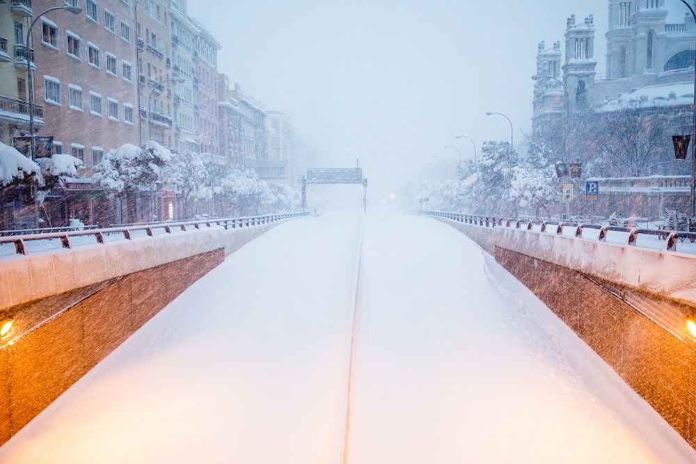 white concrete bridge near city buildings during daytime