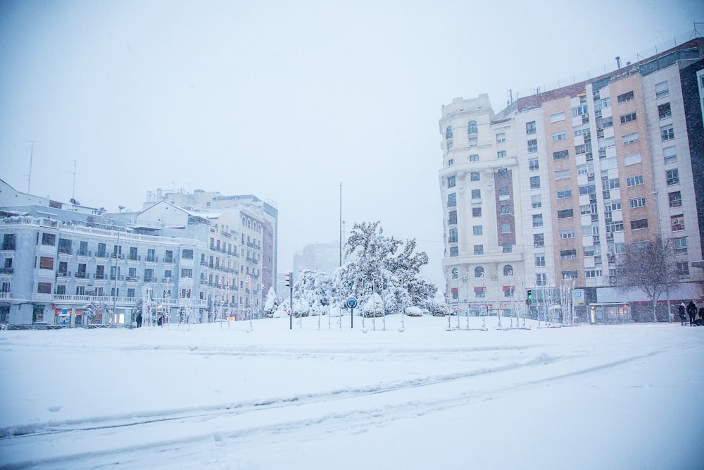 white snow covered field near white concrete building during daytime