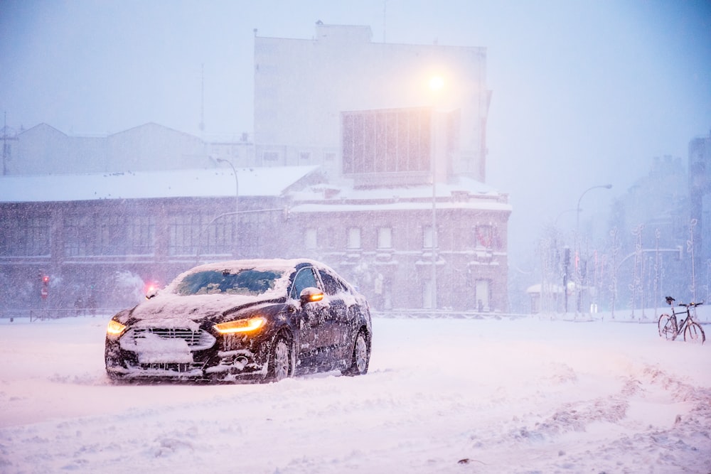 yellow and black sports car on snow covered road during daytime